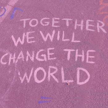 photo of text written in chalk on the street that says "together we will change the world"